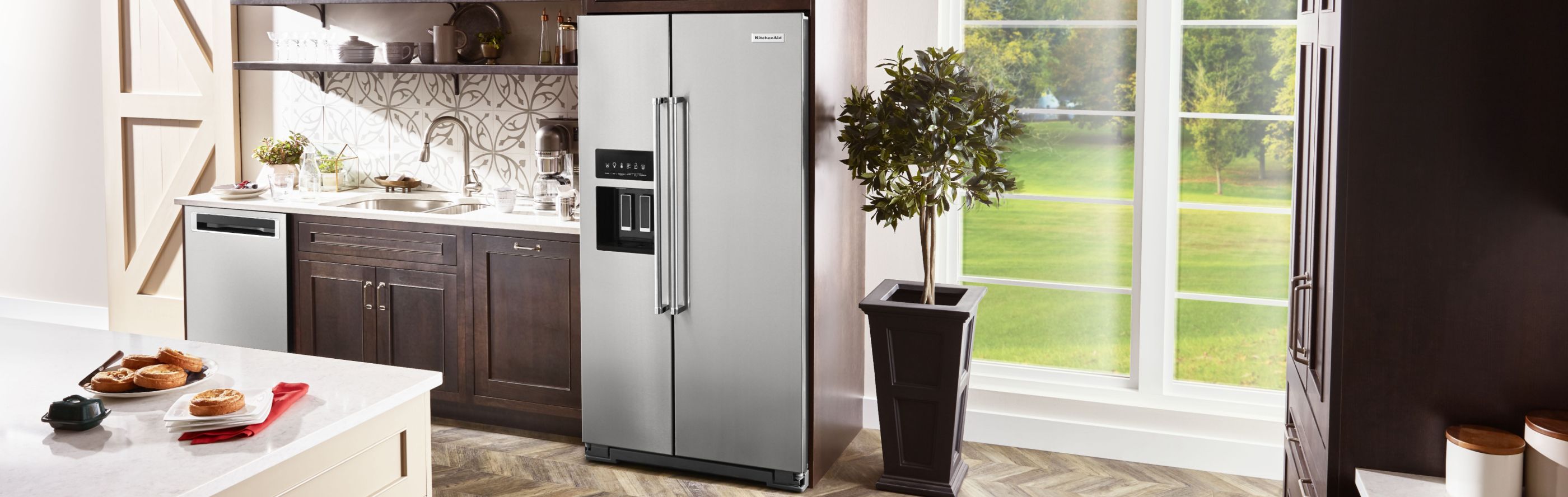 KitchenAid® side-by-side refrigerator in brown cabinetry 