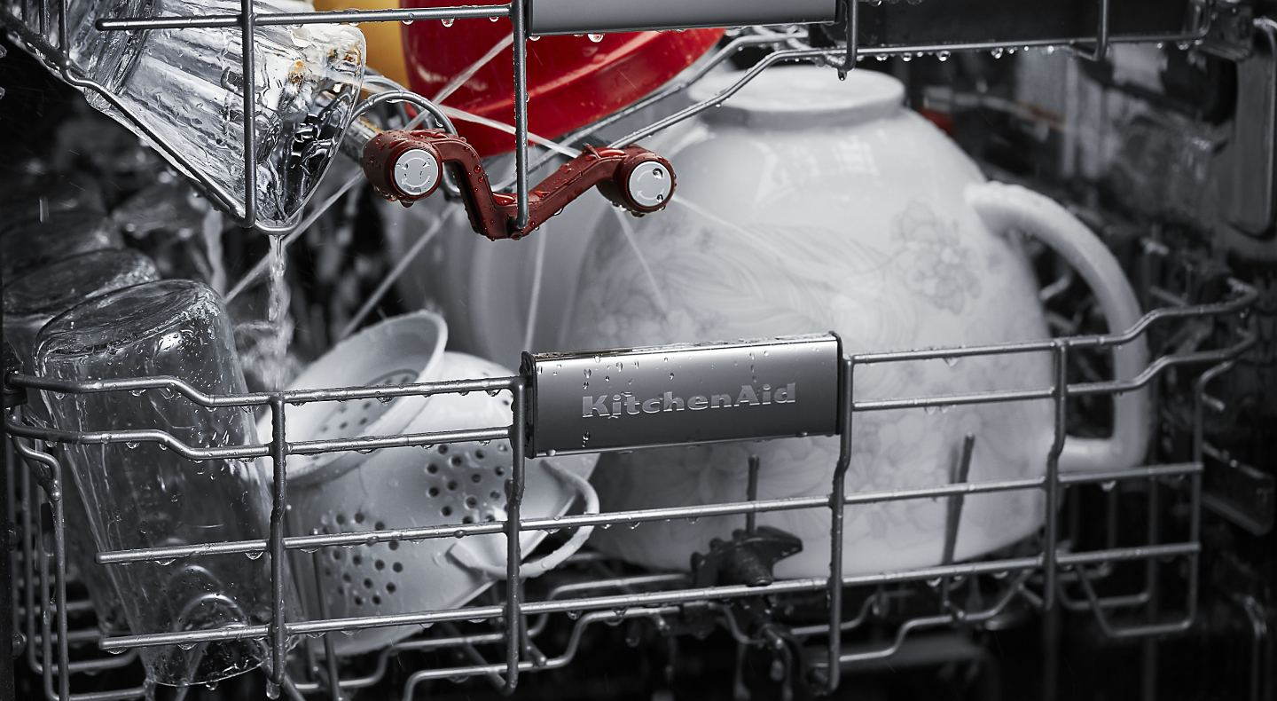 A closeup of the bottom rack of a KitchenAid® dishwasher with dishware.
