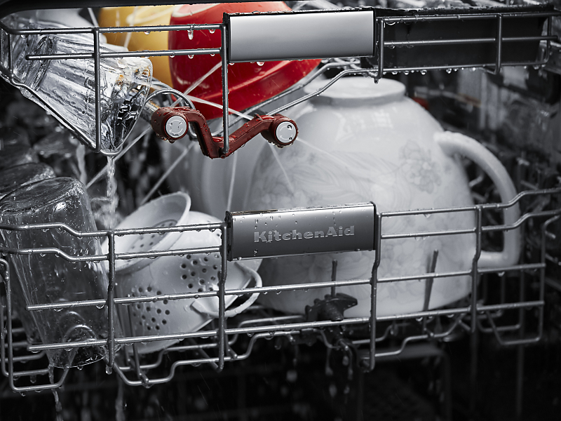 A closeup of the bottom rack of a KitchenAid® dishwasher with dishware.