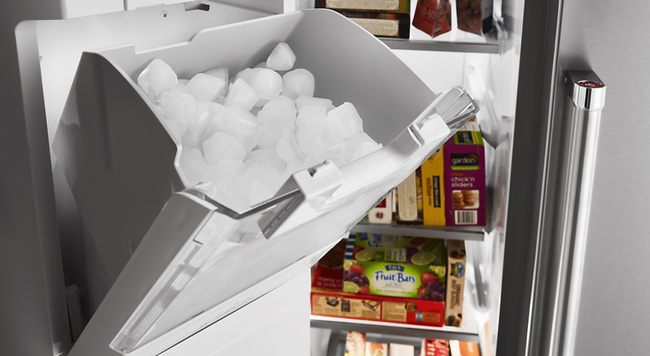 Refrigerator ice dispenser storage bucket filled with ice