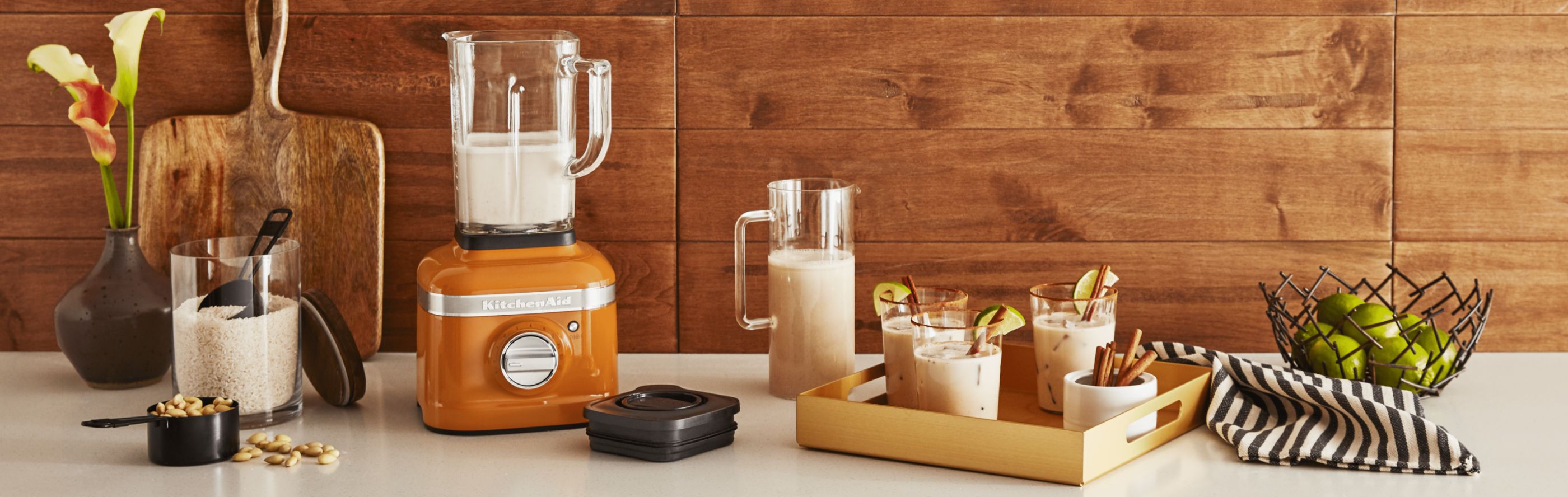 KitchenAid® blender with orange base half-filled with almond milk