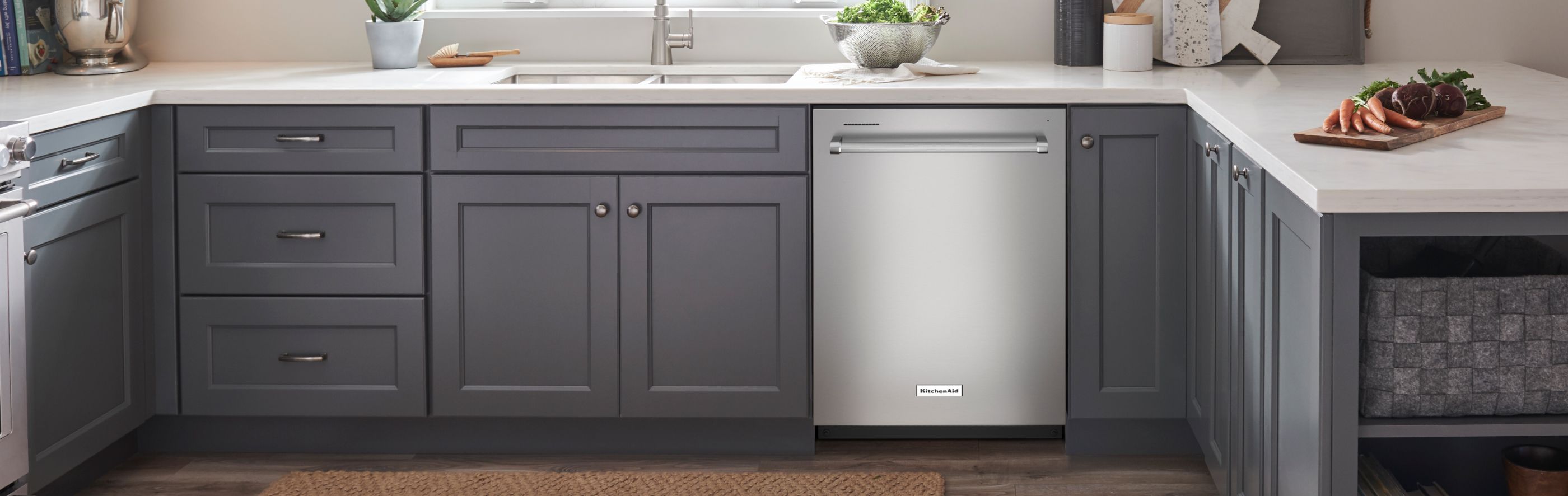 Silver KitchenAid® dishwasher in dark gray cabinetry.