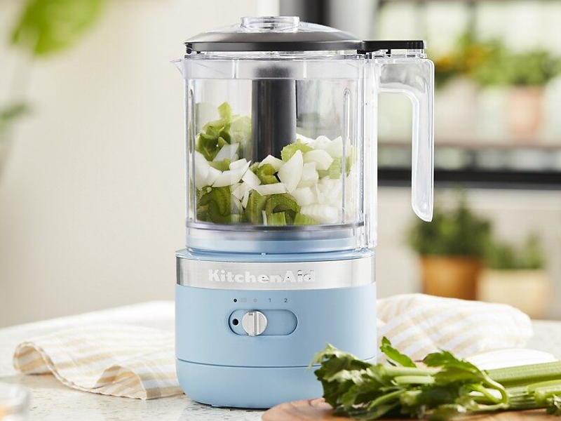 A used KitchenAid® food processor surrounded by various kitchen items