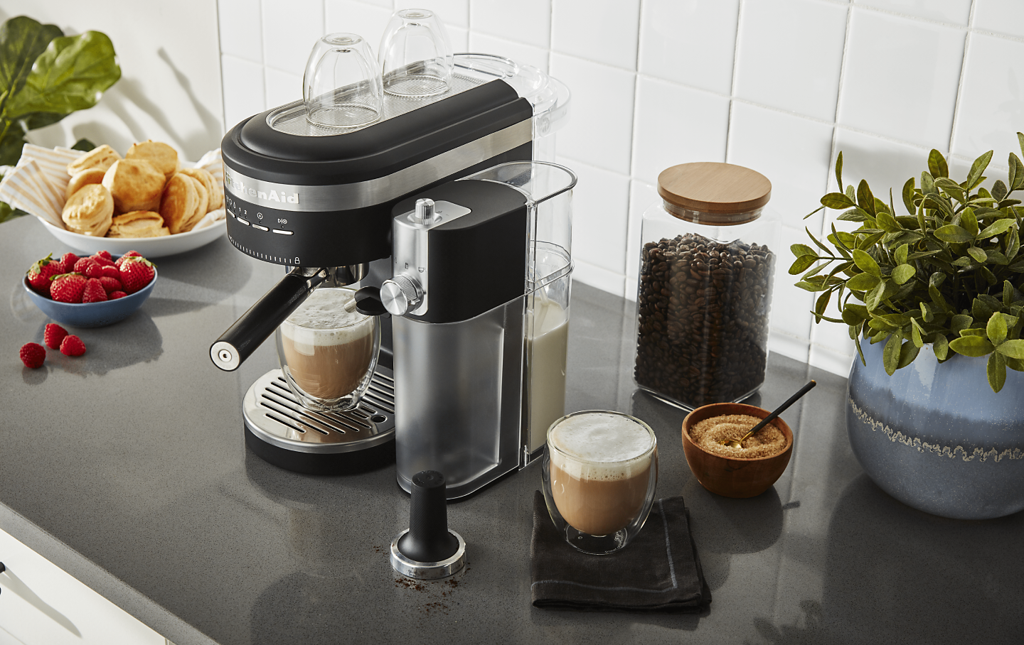 Latte in black KitchenAid® Espresso Machine with Automatic Milk Frother Attachment on counter with ingredients