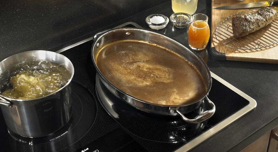 Two boiling pots on an induction cooktop.