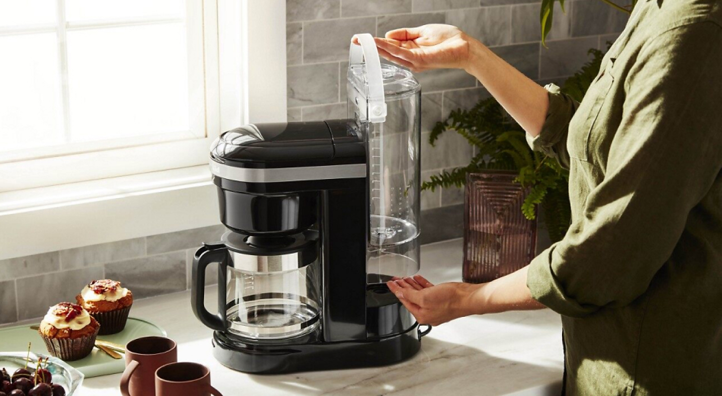 https://kitchenaid-h.assetsadobe.com/is/image/content/dam/business-unit/kitchenaid/en-us/marketing-content/site-assets/page-content/pinch-of-help/how-to-clean-and-descale-a-coffee-maker/Ihow-to-clean-and-descale-a-coffee-maker-2-Desktop.jpg?fmt=png-alpha&qlt=85,0&resMode=sharp2&op_usm=1.75,0.3,2,0&scl=1&constrain=fit,1