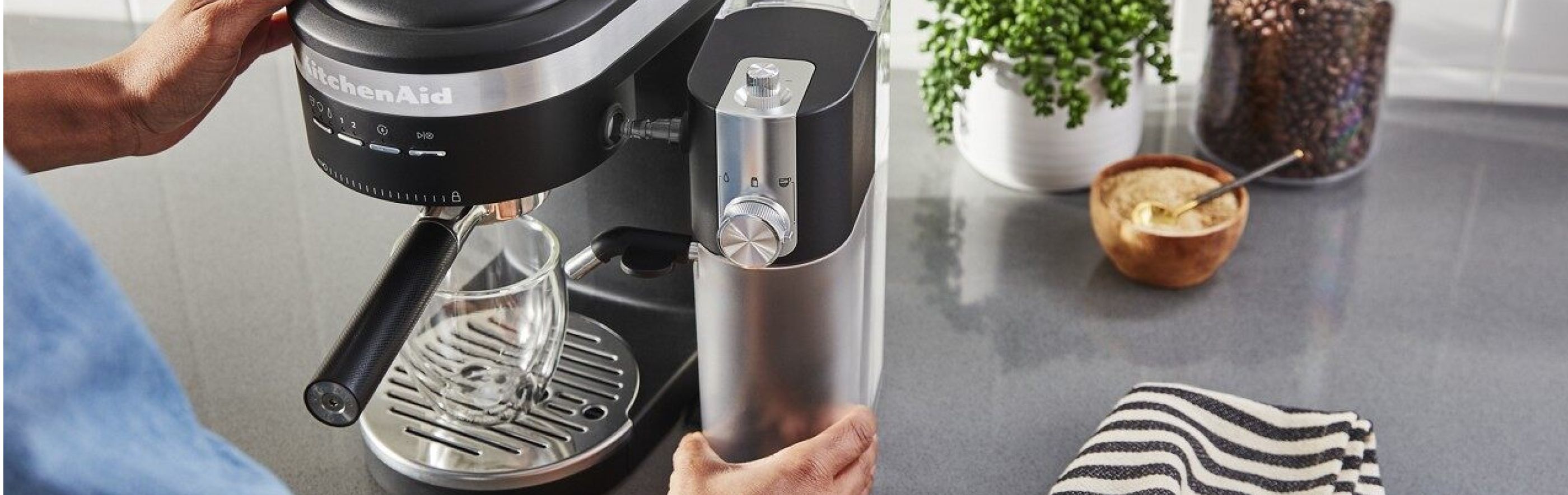  Hand replacing water tank in KitchenAid® espresso maker