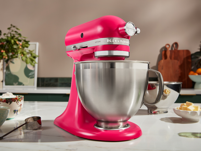 Hot pink KitchenAid® stand mixer on counter next to ingredients