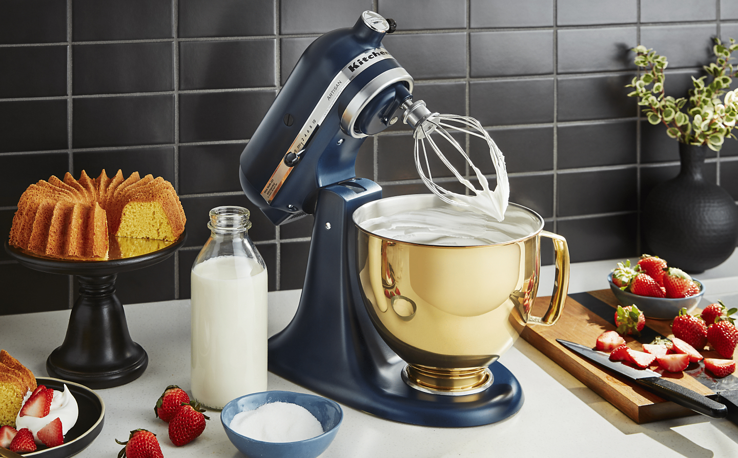 KitchenAid® stand mixer with whipped cream on a kitchen counter 