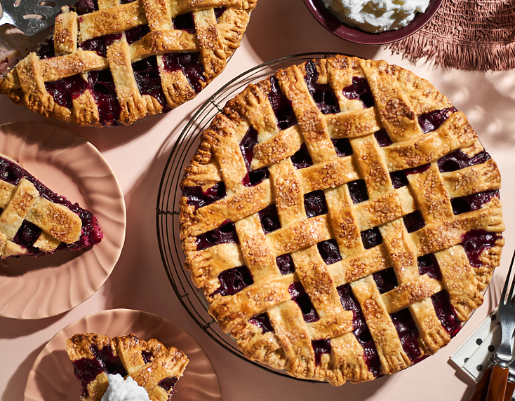 Blueberry lattice pie with plates of pie slices Blueberry lattice pie with plates of pie slices