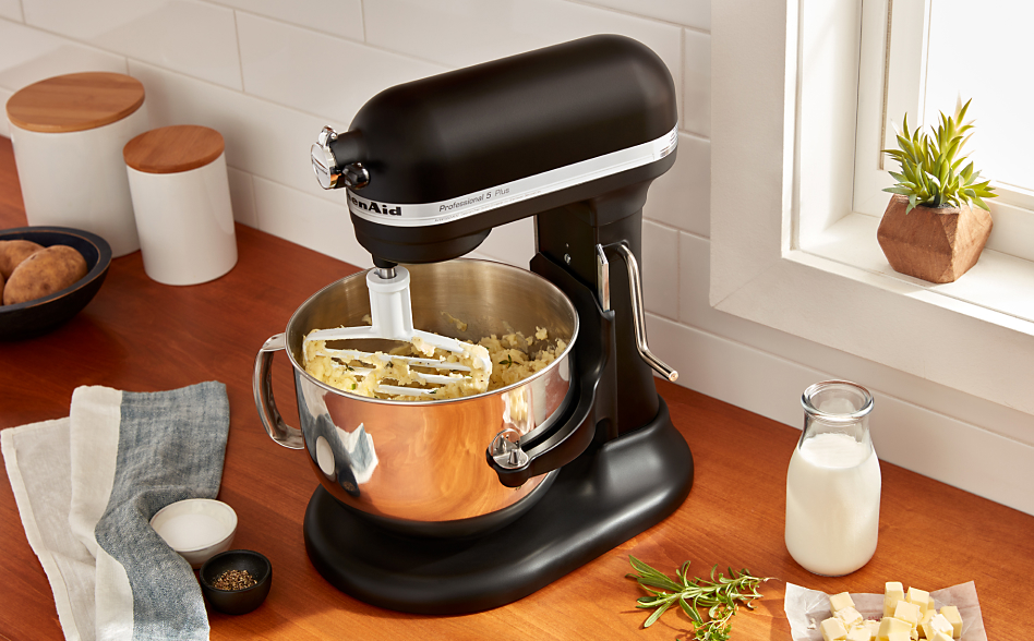 Black KitchenAid® Stand Mixer with pastry blender attachment mixing a dough
