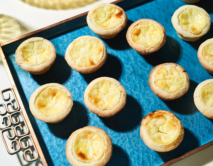 Sweet cheese tarts arranged on tray Sweet cheese tarts arranged on tray