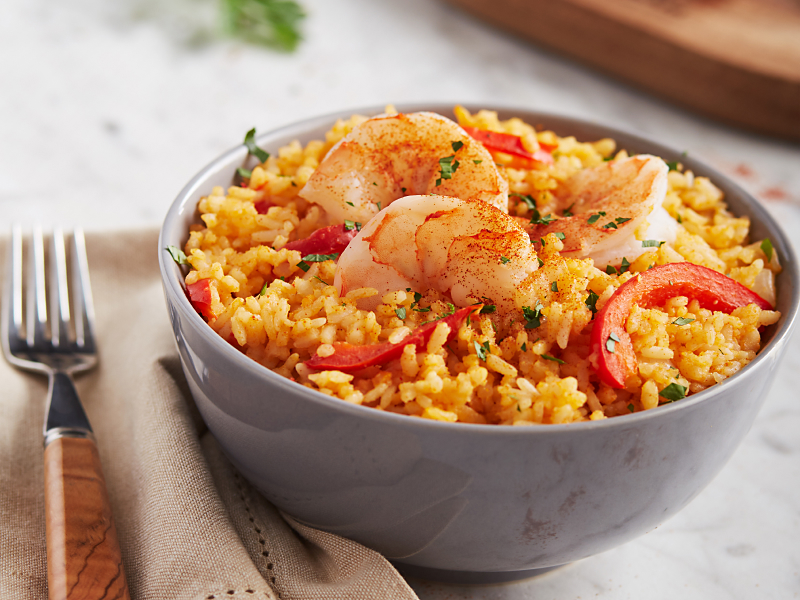 Spanish paella with shrimp in a gray bowl