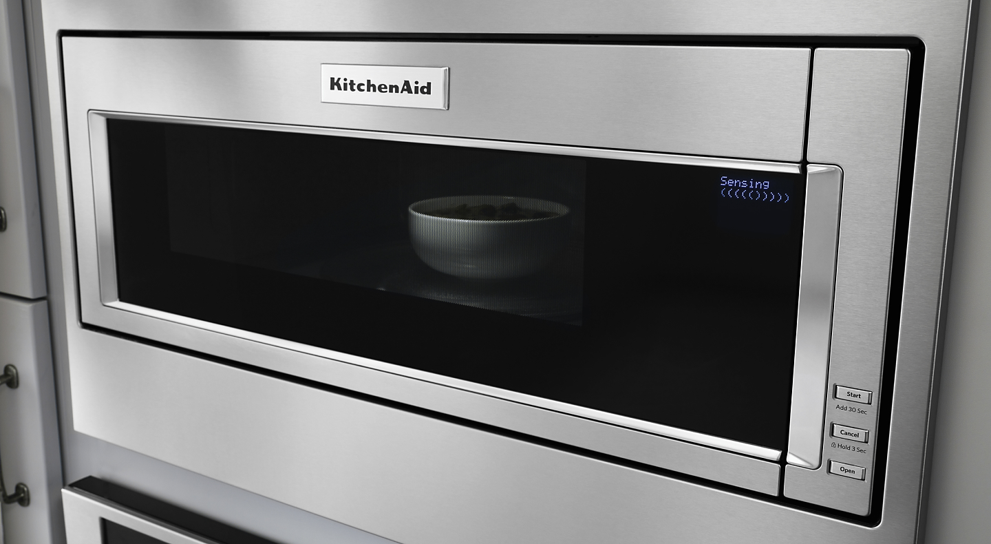 A bowl of food in a stainless steel KitchenAid® built-in microwave with sensor cooking