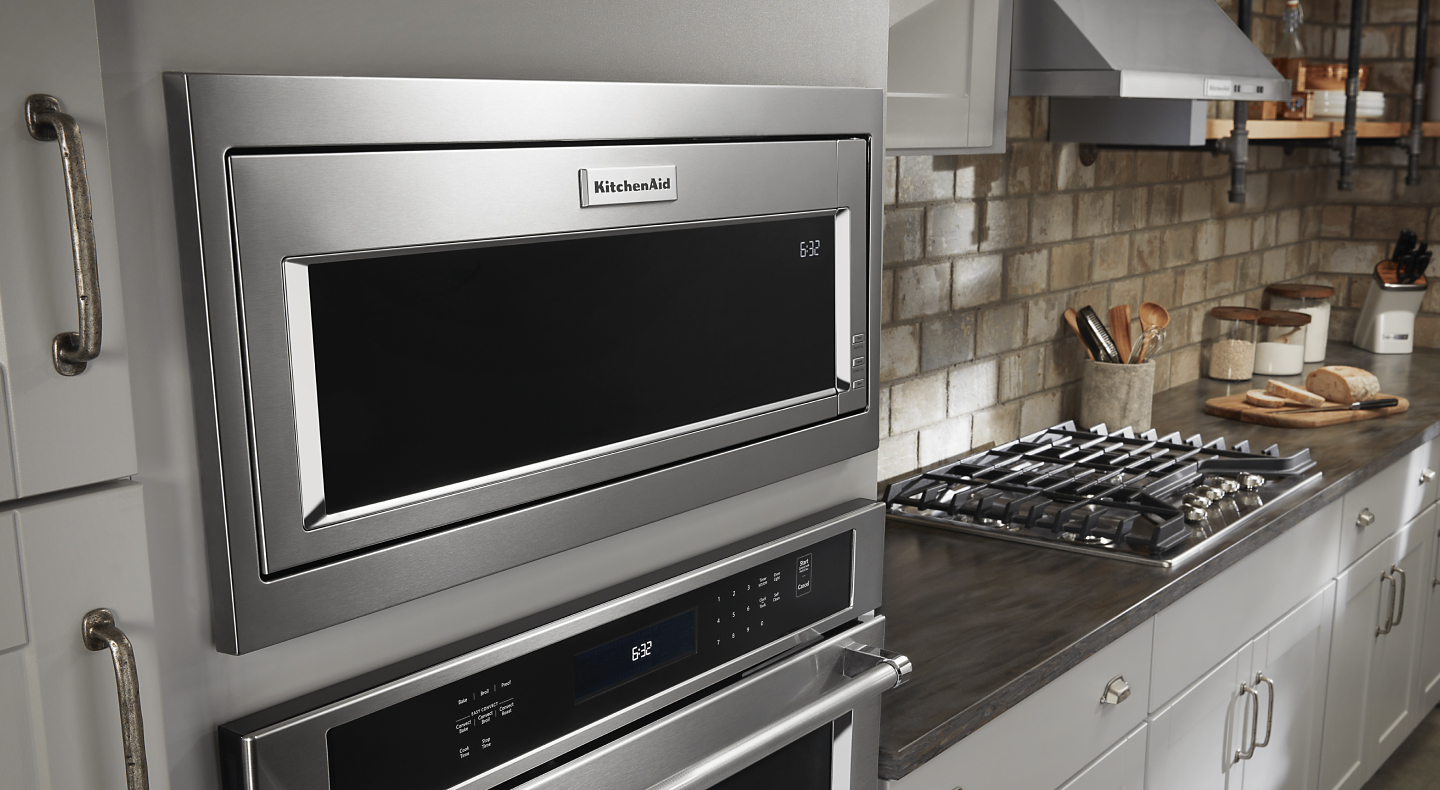 A KitchenAid® built-in microwave over a stainless steel wall oven