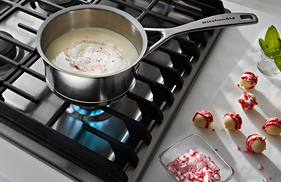 White chocolate melting on a gas cooktop