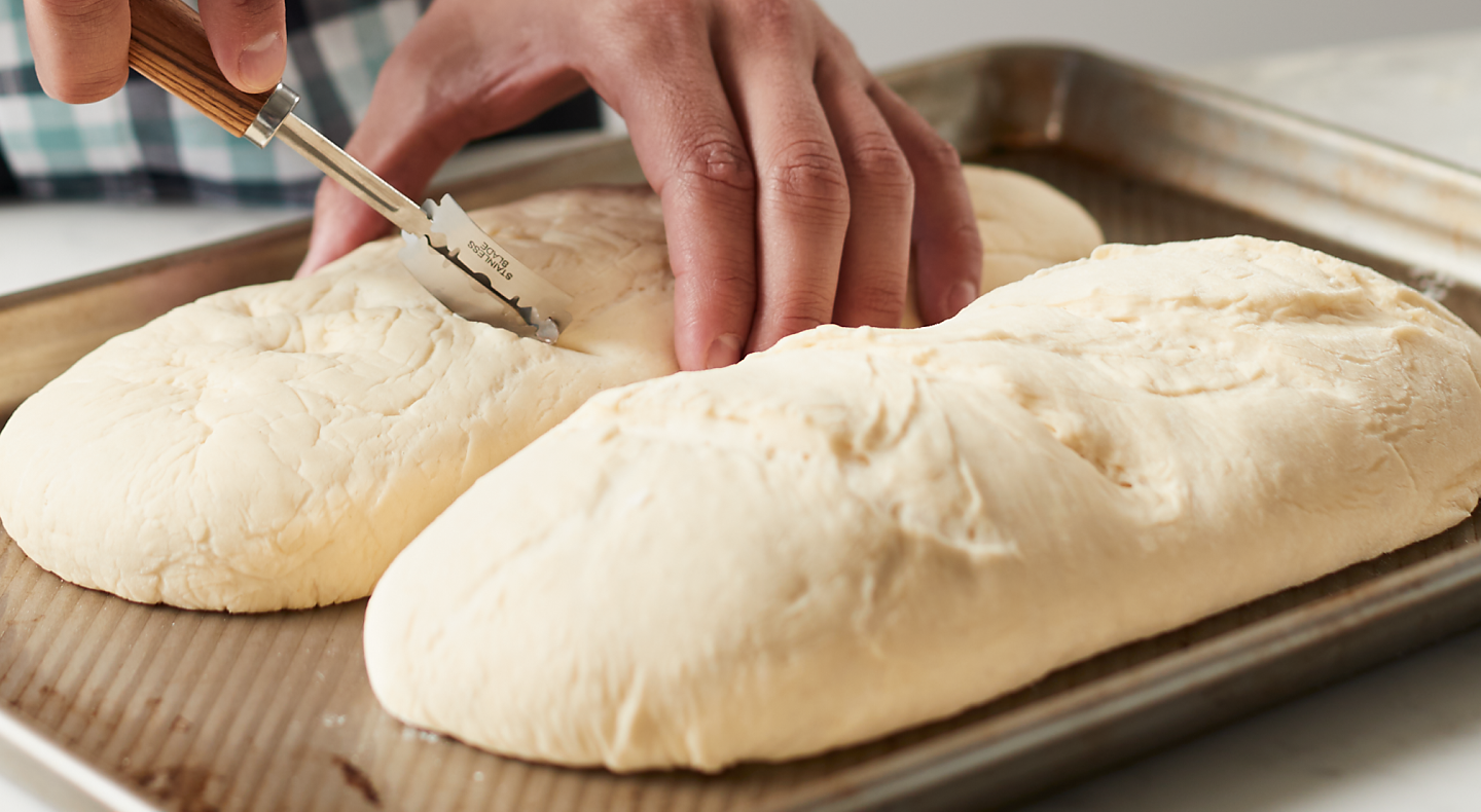 Making cuts in bread dough