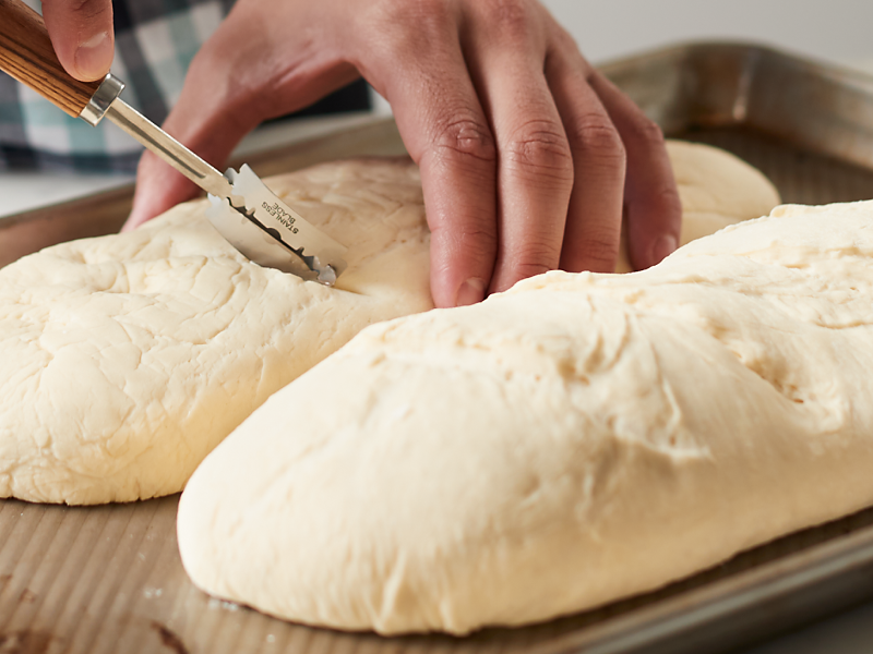 Making cuts in bread dough