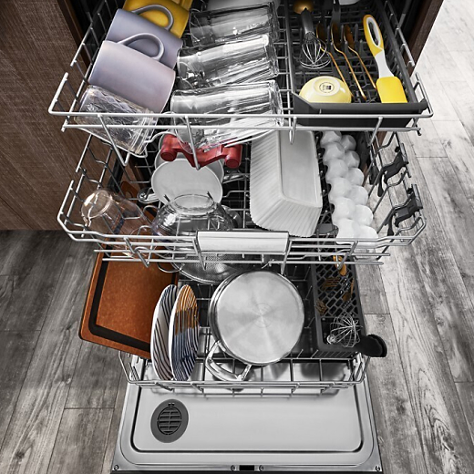 View of a loaded dishwasher with its door open