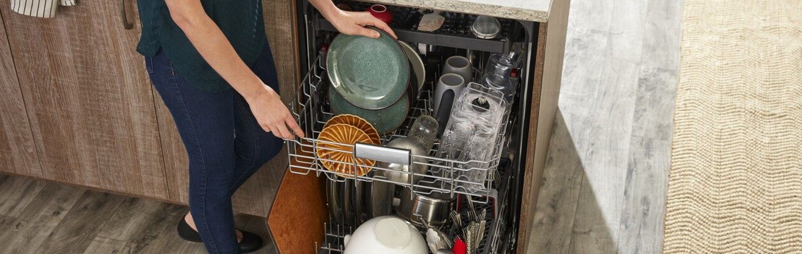 Woman loading dishes into dishwasher
