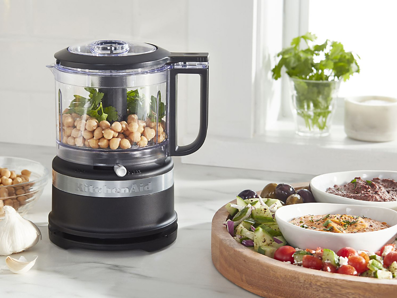 A KitchenAid® food processor full of charcuterie ingredients