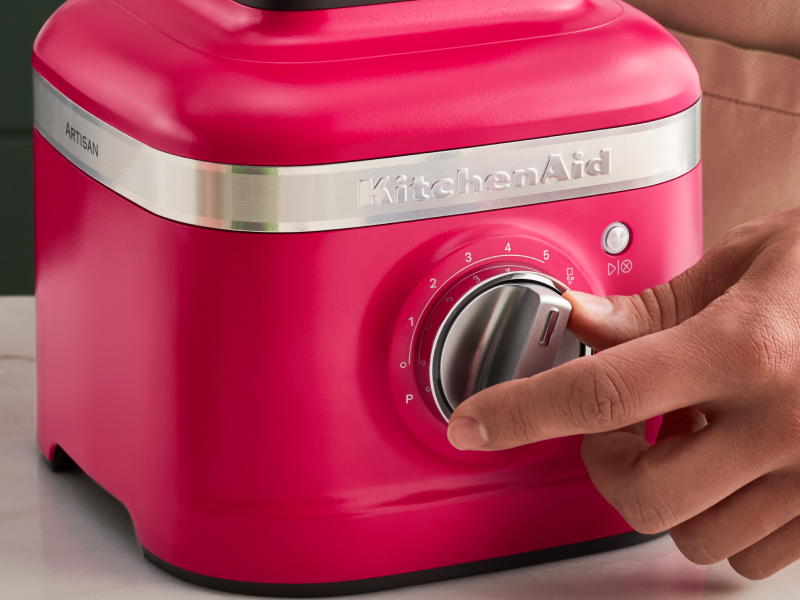 Person turning a knob on a KitchenAid® blender