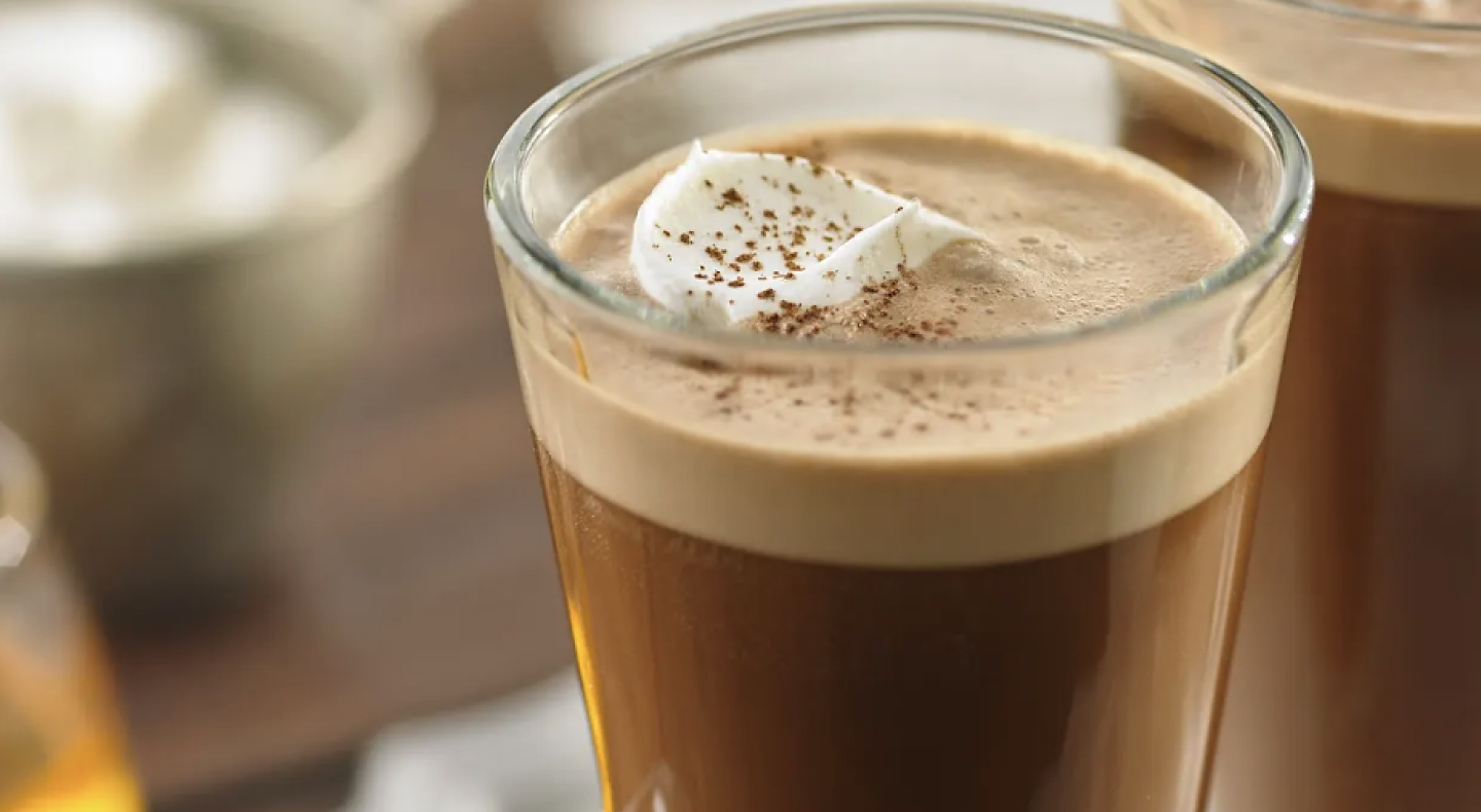 An espresso drink with a dollop of whipped cream.
