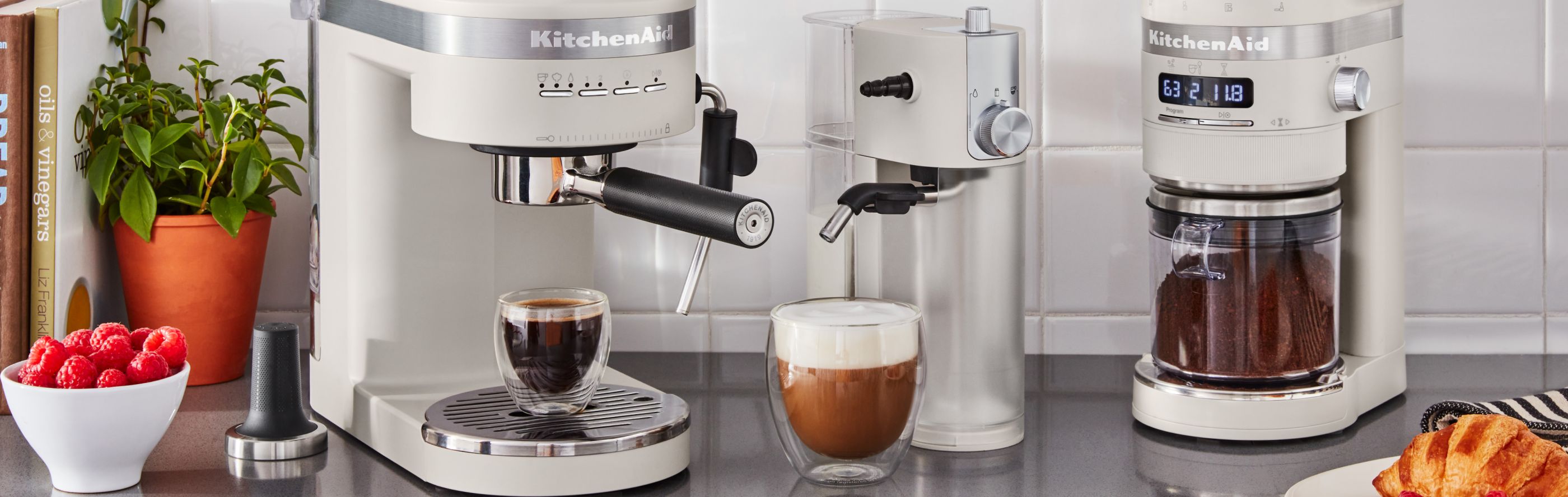 Three KitchenAid® coffee machines on a counter.