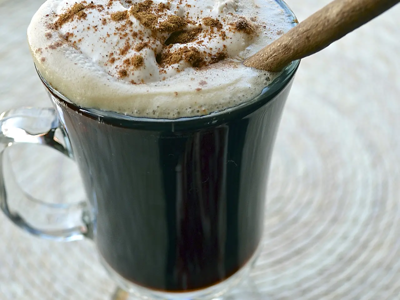 Hot Irish coffee topped with whipped cream and cinnamon