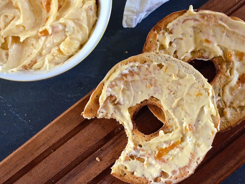 Apricot cheese spread on a bagel