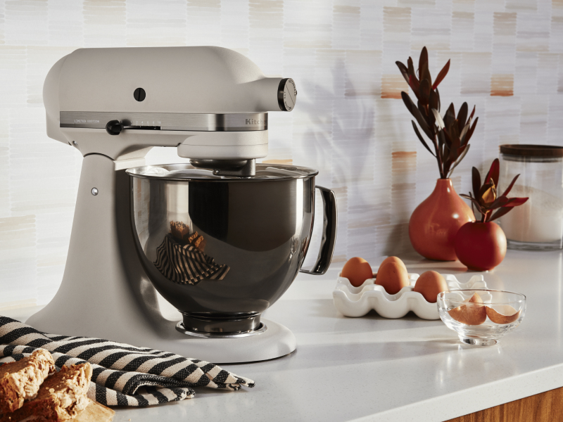 KitchenAid® stand mixer whipping egg whites in a modern kitchen.