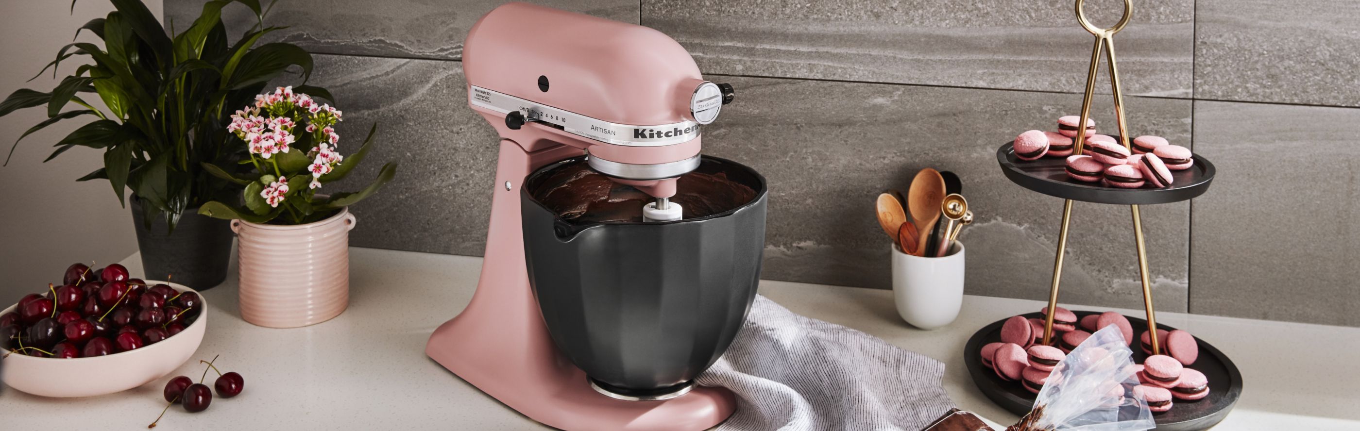 Pink KitchenAid® stand mixer next to pink macarons