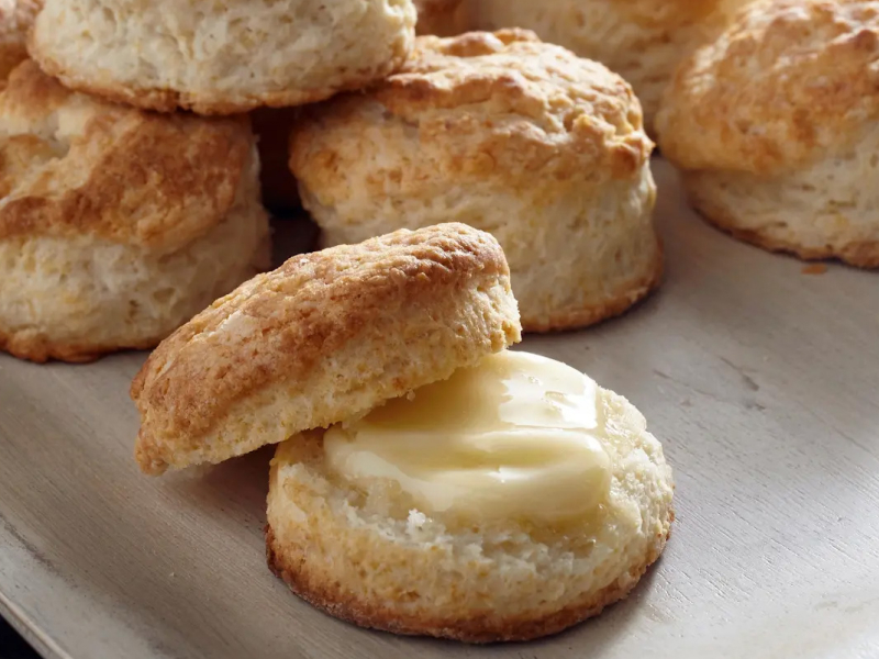 Cut biscuit with pat of butter on it