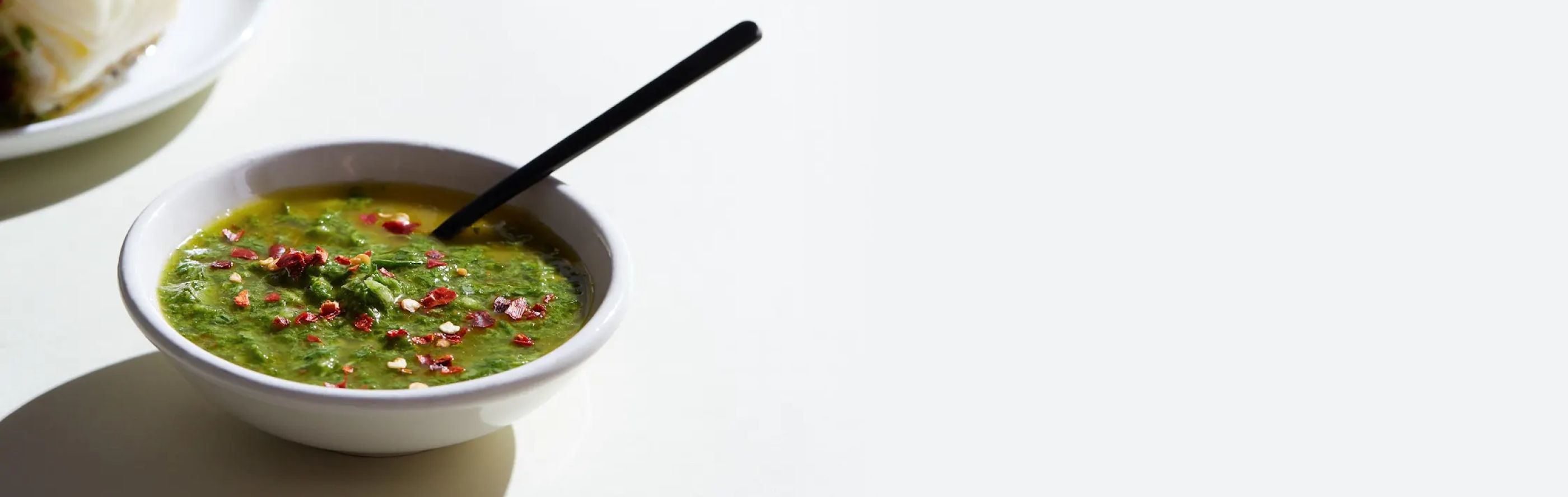 White bowl filled with chimichurri