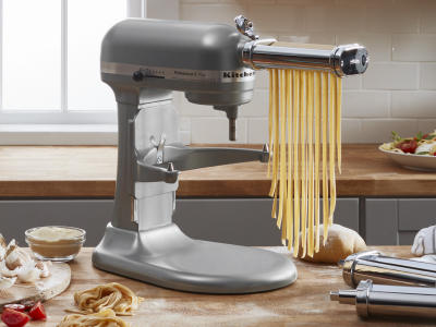 Long noodles being cut by a KitchenAid® stand mixer with the Pasta Roller Attachment