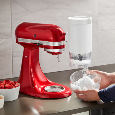 A red KitchenAid® Stand Mixer with Shave Ice Attachment.