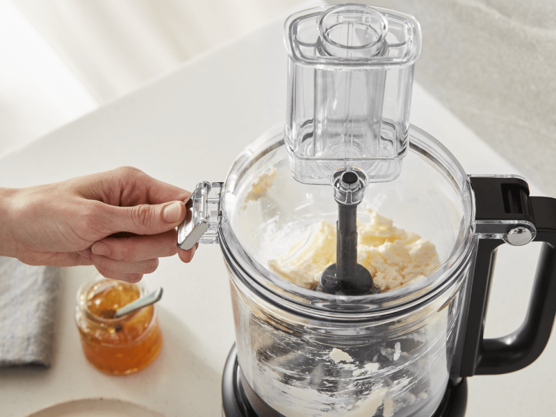  Person using food processor to process ingredients
