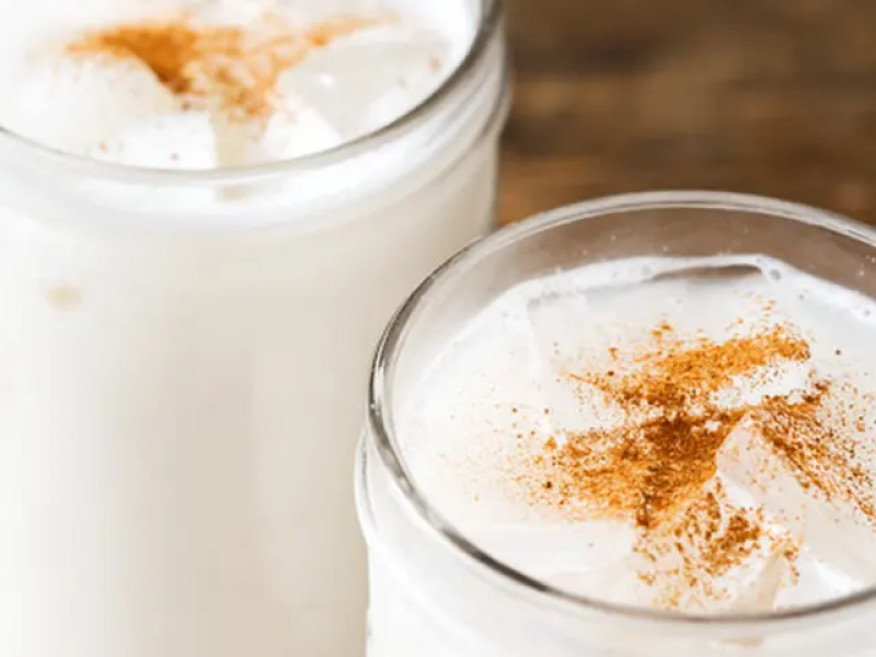 Horchata in a glass with cinnamon sprinkled on top