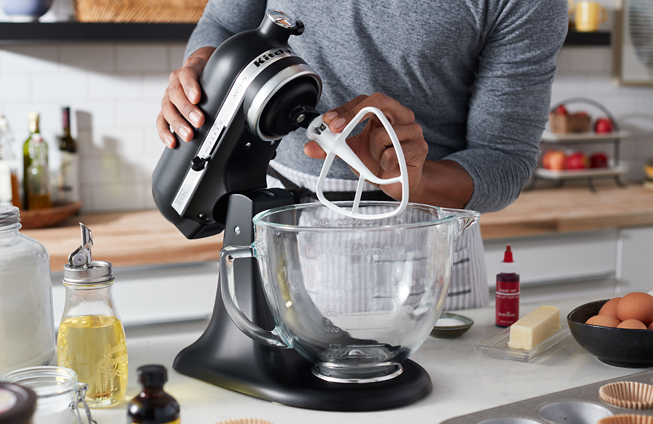 A KitchenAid® tilt-head stand mixer next to ingredients for making a cake