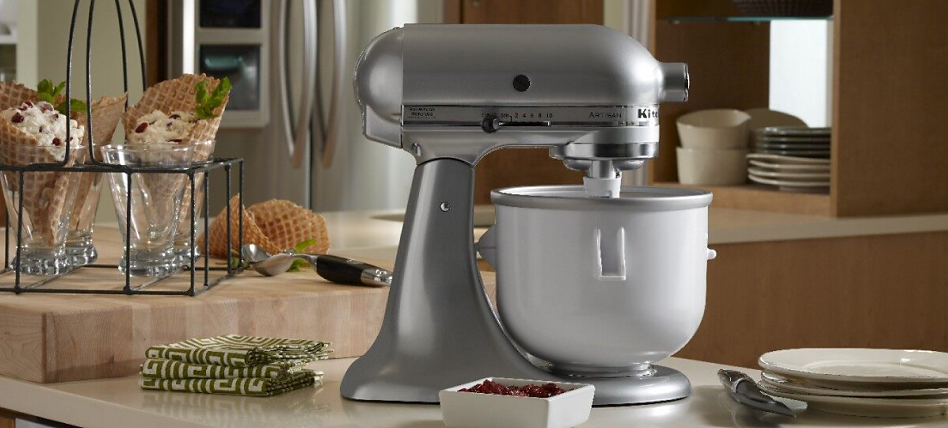 A silver KitchenAid® stand mixer next to waffle cones