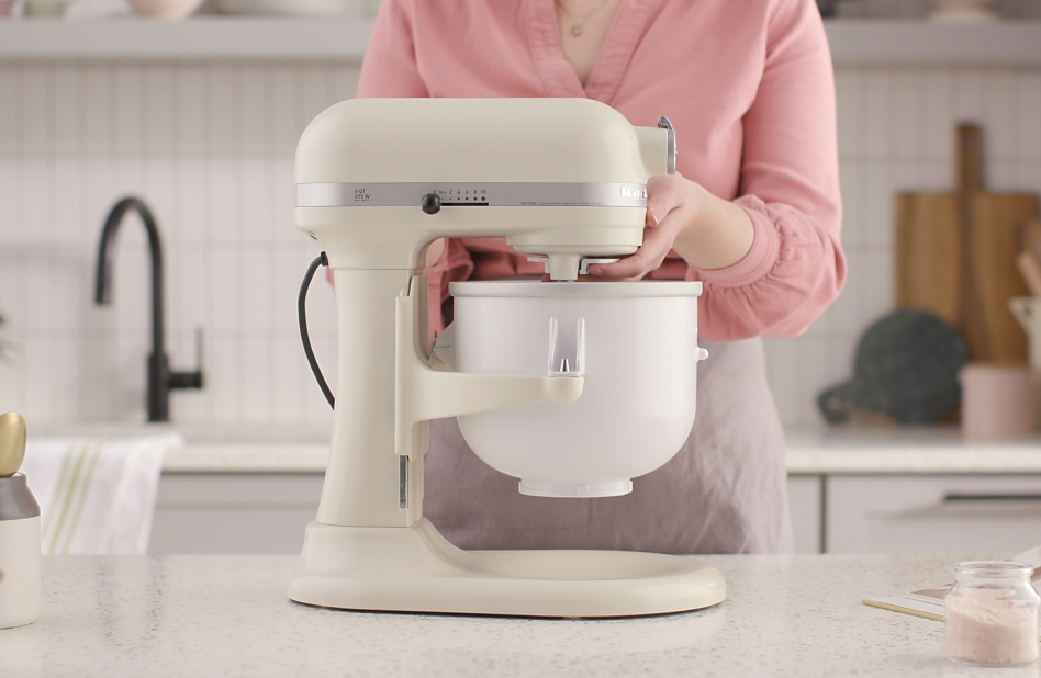 Woman Securing ice cream maker attachment to stand mixer