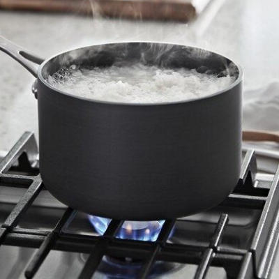 Water boiling in a saucepan on a gas cooktop