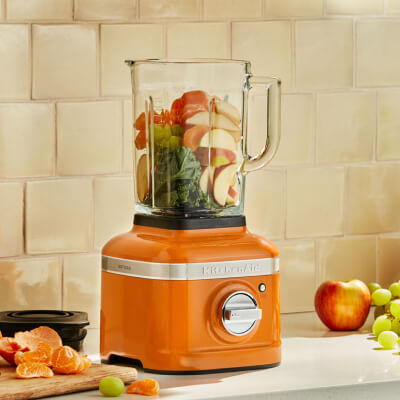 Fruits and vegetables in an orange KitchenAid® blender