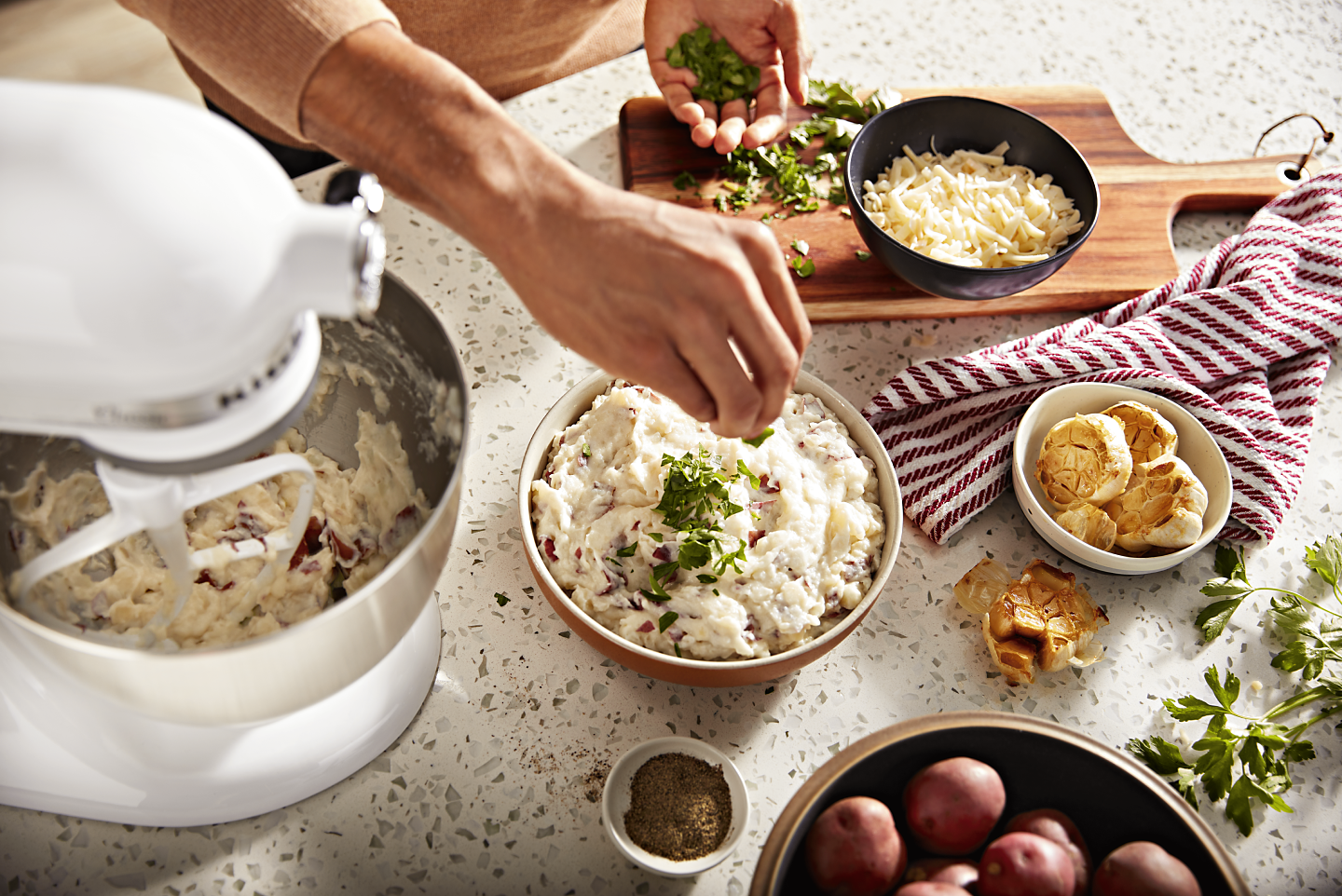 https://kitchenaid-h.assetsadobe.com/is/image/content/dam/business-unit/kitchenaid/en-us/marketing-content/site-assets/page-content/pinch-of-help/how-to-make-mashed-potatoes-with-a-stand-mixer/Mashed-Potato-Stand-Mixer_3.png?fmt=png-alpha&qlt=85,0&resMode=sharp2&op_usm=1.75,0.3,2,0&scl=1&constrain=fit,1