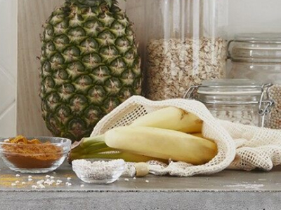 A pineapple and bananas on a kitchen counter