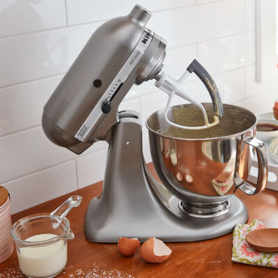 KitchenAid® stand mixer with milk and eggs on counter