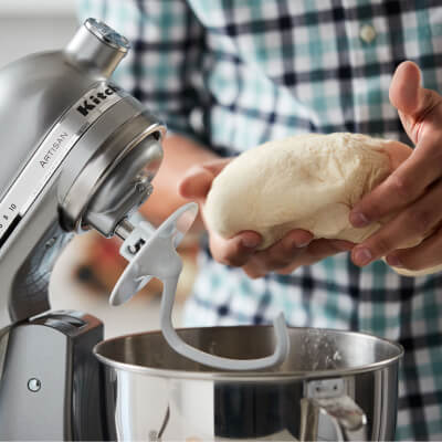 Dough being removed from bowl of KitchenAid® stand mixer