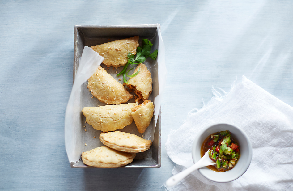 Hand pies made with a food processor in a dish with dipping sauce