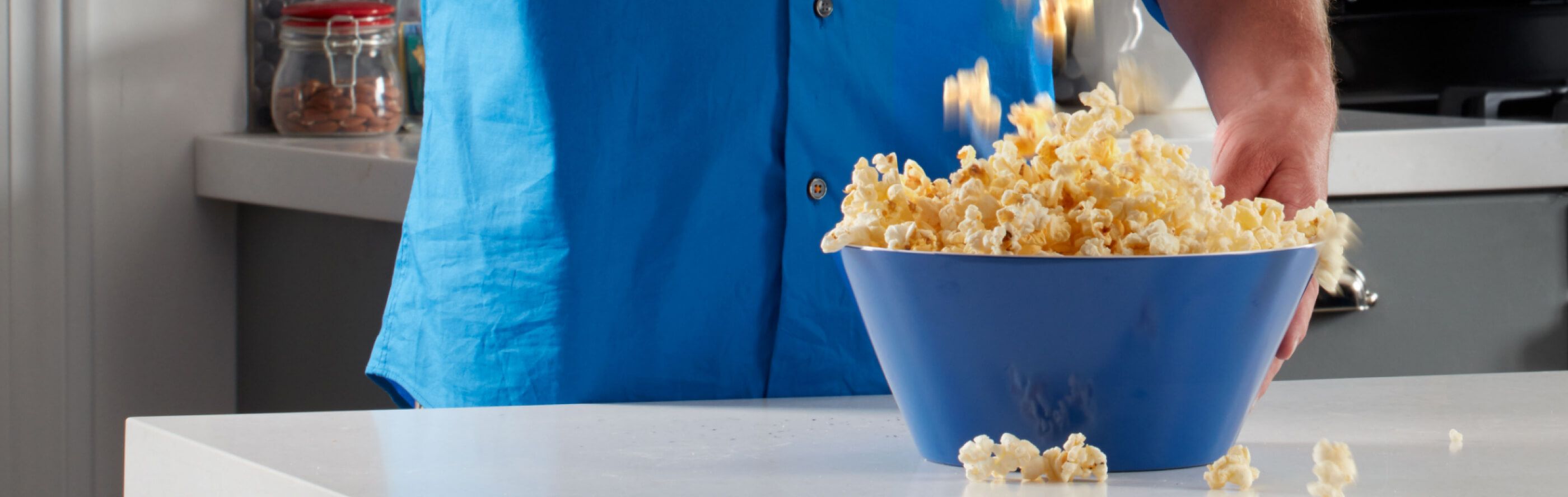 Blue bowl of popcorn on a countertop