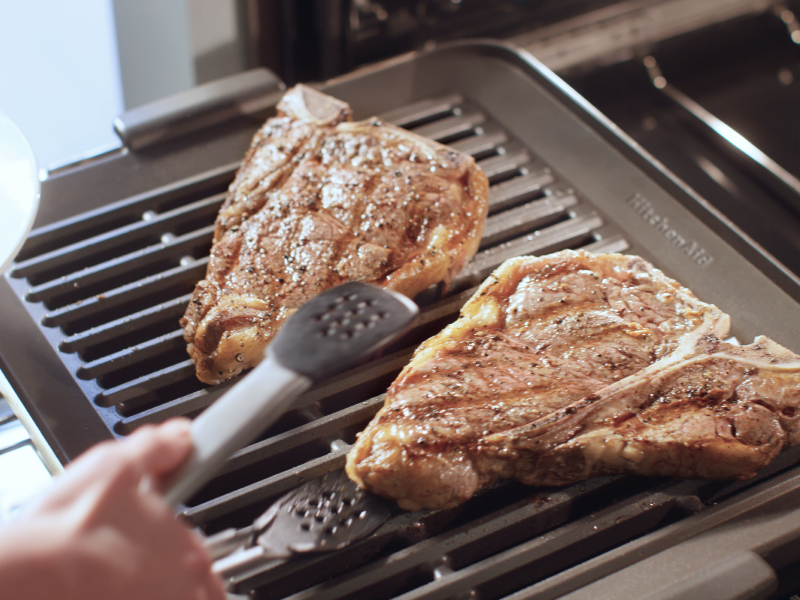 Two pork loins searing on a KitchenAid® Smart Oven+ Grill Attachment